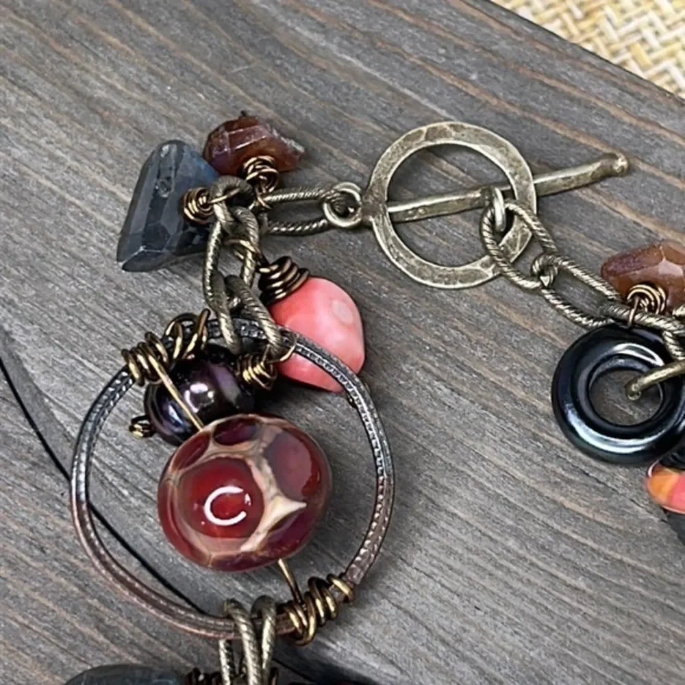 Artistic bracelet with wire wrapped stones.